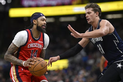 New Orleans Pelicans forward Brandon Ingram (14) is defended by Orlando Magic center Moritz Wagner (21) during the first half of an NBA basketball game, Thursday, March 21, 2024, in Orlando, Fla. (AP Photo/Phelan M. Ebenhack)
