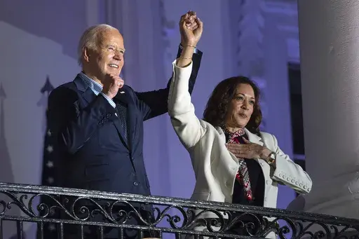 President Joe Biden raises the hand of Vice President Kamala Harris after viewing the Independence Day fireworks display over the National Mall from the balcony of the White House, Thursday, July 4, 2024, in Washington. She's already broken barriers, and now Harris could soon become the first Black woman to head a major party's presidential ticket after President Joe Biden's ended his reelection bid. The 59-year-old Harris was endorsed by Biden on Sunday, July 21, after he stepped aside amid wid