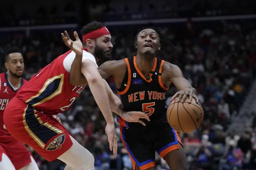 New York Knicks guard Immanuel Quickley (5) battles against New Orleans Pelicans forward Larry Nance Jr. in the second half of an NBA basketball game in New Orleans, Friday, April 7, 2023. The Pelicans won 113-105. (AP Photo/Gerald Herbert)