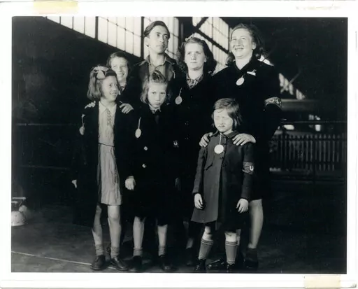 In this May 26, 1946, photo, Ginger Lane, bottom right, and her siblings arrive in New York City as Holocaust survivors who were hidden in a fruit orchard near Berlin by non-Jews. Their mother was killed at the death camp at Auschwitz. Lane has since made it her lifelong mission to educate others of this painful past. (Courtesy Ginger Lane via AP)