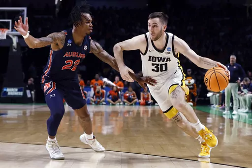 Iowa guard Connor McCaffery (30) drives to the basket as Auburn forward Yohan Traore (21) defends during the second half of a first-round college basketball game in the men's NCAA Tournament in Birmingham, Ala., Thursday, March 16, 2023. Auburn won 83-75. (AP Photo/Butch Dill)