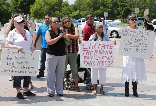 Participants listen during a rally in support of three-year-old baby Veronica, Veronica's biological father, Dusten Brown, and the Indian Child Welfare Act, in Oklahoma City, Monday, Aug. 19, 2013. Brown is trying to maintain custody of the girl who was given up for adoption by her birth mother to Matt and Melanie Capobianco of South Carolina. The U.S. Supreme Court will hear arguments, Wednesday, Nov. 9, 2022 on the most significant challenge to the Indian Child Welfare Act that gives preferenc