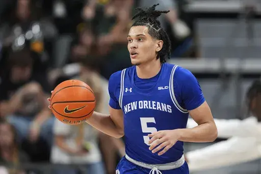 New Orleans's James White handles the ball during an NCAA college basketball game against Baylor, Wednesday, Nov. 27, 2024, in Waco, Texas. (AP Photo/Tony Gutierrez)