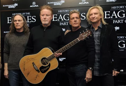 Members of The Eagles, from left, Timothy B. Schmit, Don Henley, Glenn Frey and Joe Walsh pose with an autographed guitar after a news conference at the Sundance Film Festival, Jan. 19, 2013, in Park City, Utah. On Wednesday, Feb. 21, 2024, an unusual criminal trial is set to open over the handwritten lyrics to the band's classic rock blockbuster' “Hotel California.” (Photo by Chris Pizzello/Invision/AP, File)