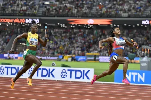 FILE = Sha'Carri Richardson, of the United States celebrates anchoring her team to gold ahead of Shericka Jackson, of Jamaica in the Women's 4x100-meters relay final during the World Athletics Championships in Budapest, Hungary, Saturday, Aug. 26, 2023. When all the other fastest runners and best jumpers and throwers of 2024 line up for the Olympic track and field meet, little of what they've done on the road to Paris will mean much. What will matter is how they respond to pressure when the spot