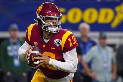 Southern California quarterback Caleb Williams (13) looks to pass during the first half of the Cotton Bowl NCAA college football game against Tulane, Monday, Jan. 2, 2023, in Arlington, Texas. (AP Photo/Sam Hodde)