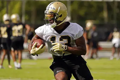 New Orleans Saints wide receiver Michael Thomas (13) runs after a reception during the NFL football team's training camp in Metairie, La., Wednesday, July 27, 2022. Thomas practiced on Wednesday, Sept. 7, 2022, for the first time since Aug. 18, after working his way back from a hamstring injury. Thomas set a single-season record in 2019 with 149 receptions but missed all of last season because of complications from an ankle injury that also sidelined him for much of the 2020 season. His goal, he