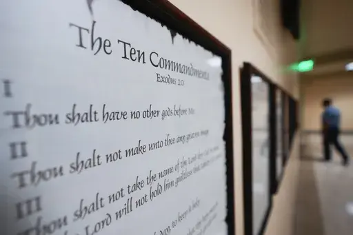 A copy of the Ten Commandments is posted along with other historical documents in a hallway of the Georgia Capitol, Thursday, June 20, 2024, in Atlanta. In motions filed Monday, July 8, 2024, parents challenging a new Louisiana law requiring that the Ten Commandments be posted in public school classrooms are asking a federal court to block implementation of it while their lawsuit progresses — and before the new school year starts. (AP Photo/John Bazemore, File)