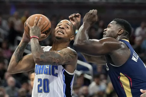 Orlando Magic guard Markelle Fultz (20) looks for a shot against New Orleans Pelicans forward Zion Williamson during the first half of an NBA preseason basketball game, Tuesday, Oct. 17, 2023, in Orlando, Fla. (AP Photo/John Raoux)