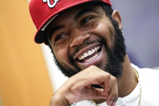 Former Southern University football player Devon Gales smiles as he speaks during an interview Friday, Dec. 16, 2022, at Jefferson Academy in Jefferson, Ga. Gales, who suffered a spinal cord injury and left paralyzed during a game against Georgia in 2015, works at the school while finishing his college degree at Georgia. . (AP Photo/John Bazemore)