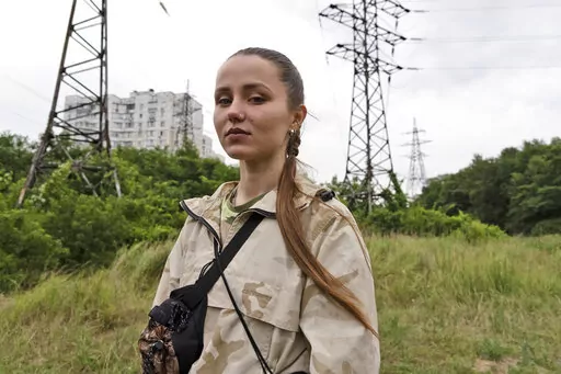 Instructor Ilona Khomenko looks on during a first aid training to master the MARCH algorithm according to the NATO protocol, in Kyiv, Ukraine, Monday, July 11, 2022. Khomenko’s life changed on May 23, when her husband died fighting the near Severodonetsk in eastern Ukraine. Now she keeps him close by helping to train soldiers and civilians how to survive on the battlefield. (AP Photo/Vasilisa Stepanenko)