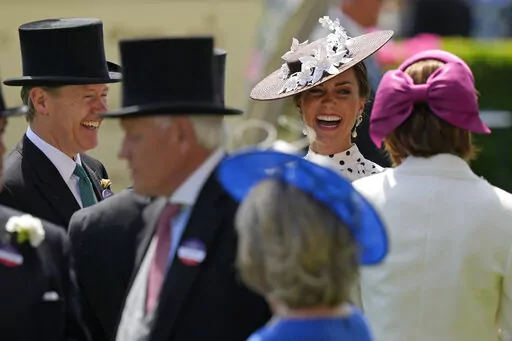 Kate, Duchess of Cambridge, second right, laughs as she stands in the paddock on the fourth day of the Royal Ascot horserace meeting, at Ascot Racecourse, in Ascot, England, Friday, June 17, 2022. Every June, Britain's royals, aristocrats and thousands of stylish guests don their finest headgear for Royal Ascot, a glamorous annual horse racing event that dates back to 1711, when Queen Anne founded Ascot Racecourse in Berkshire, southern England. (AP Photo/Alastair Grant)