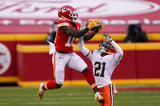 Kansas City Chiefs wide receiver Tyreek Hill makes a catch over Cleveland Browns cornerback Denzel Ward (21) during the second half of an NFL divisional round football game, Sunday, Jan. 17, 2021, in Kansas City. The Kansas City Chiefs traded wide receiver Tyreek Hill to Miami for a package of draft picks on Wednesday, March 23, 2022, and the Dolphins are giving the three-time All-Pro a $120 million, four-year contract extension, a person familiar with the moves told The Associated Press. (AP Ph