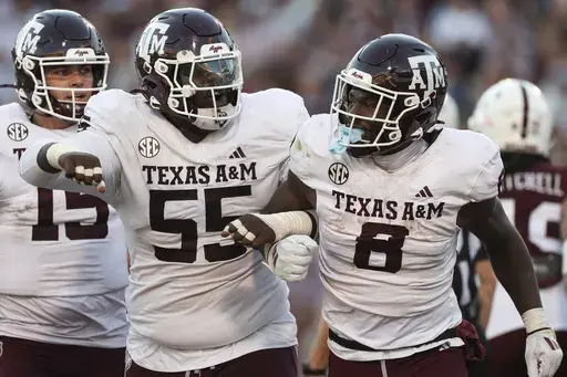 Texas A&M offensive lineman Ar'maj Reed-Adams (55) and running back Le'Veon Moss (8) react during the second half of an NCAA college football game against Mississippi State, Saturday, Oct. 19, 2024, in Starkville, Miss. (AP Photo/Randy J. Williams)