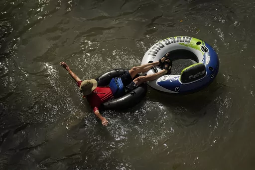 A tuber floats on the Comal River, July 26, 2023, in New Braunfels, Texas, as the area continues to feel the effects of triple-digit temperatures. Record setting temperatures are expected Saturday, Aug. 19, across Texas as the southwestern U.S. continues to bake during a scorching summer. (AP Photo/Eric Gay, File)