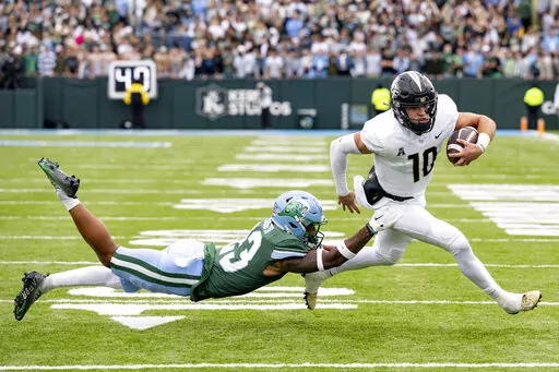 UCF quarterback John Rhys Plumlee (10) runs against Tulane safety Lummie Young IV (23) during an NCAA college football game in New Orleans, Saturday, Nov. 12, 2022. (AP Photo/Matthew Hinton)