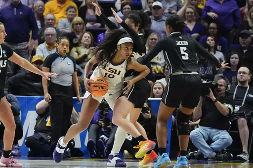 LSU forward Angel Reese (10) drives to the basket against Rice forward Malia Fisher and guard Destiny Jackson (5) during the second half of a first-round college basketball game in the women's NCAA Tournament in Baton Rouge, La., Friday, March 22, 2024. LSU won 70-60. (AP Photo/Gerald Herbert)