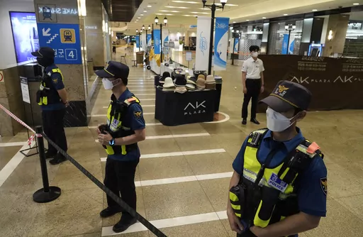 Police officers cordon off the scene near a subway station in Seongnam, South Korea, Thursday, Aug. 3, 2023. A dozen of people were injured in South Korea on Thursday when a man rammed a car onto a sidewalk and then stepped out of the vehicle and began stabbing people near a subway station in the city of Seongnam. (AP Photo/Ahn Young-joon)
