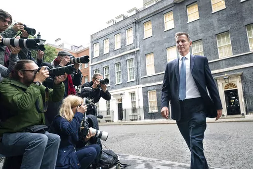 Jeremy Hunt leaves 10 Downing Street in London after he was appointed Chancellor of the Exchequer following the resignation of Kwasi Kwarteng, Friday Oct. 14, 2022. Chancellor of the Exchequer Kwasi Kwarteng said he has accepted Prime Minister Liz Truss' request he "stand aside" as Chancellor, paying the price for the chaos unleashed by his mini-budget. (Stefan Rousseau/PA via AP)