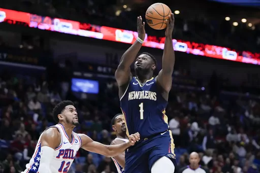 New Orleans Pelicans forward Zion Williamson (1) drives to the basket against Philadelphia 76ers forward Tobias Harris (12) in the first half of an NBA basketball game in New Orleans, Wednesday, Nov. 29, 2023. (AP Photo/Gerald Herbert)