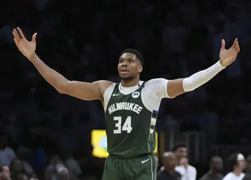 Milwaukee Bucks forward Giannis Antetokounmpo (34) reacts after Kevin Porter Jr. scored during overtime in an NBA basketball game against the Miami Heat, Saturday, April 5, 2025, in Miami. (AP Photo/Lynne Sladky)
