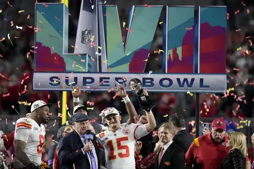 Kansas City Chiefs quarterback Patrick Mahomes (15) holds the Vince Lombardi Trophy while talking to Terry Bradshaw following the NFL Super Bowl 57 football game against the Philadelphia Eagles, Sunday, Feb. 12, 2023, in Glendale, Ariz. (AP Photo/Seth Wenig, File)