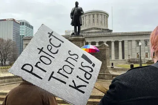 Demonstrators advocating for transgender rights and healthcare stand outside of the Ohio Statehouse, Jan. 24, 2024, in Columbus, Ohio. A federal appeals court on Wednesday, July 17, refused to lift a judge's order temporarily blocking the Biden administration’s new Title IX rule meant to expand protections for LGBTQ+ students. (AP Photo/Patrick Orsagos, File)