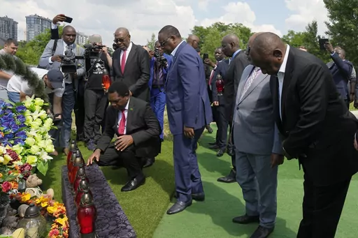 From right, South African President Cyril Ramaphosa, President of the Union of Comoros Azali Assoumani, Senegal's President Macky Sall, and Zambia's President Hakainde Hichilema, bottom, attend a commemoration ceremony at a site of a mass grave in Bucha, on the outskirts of Kyiv, Ukraine, Friday, June 16, 2023. South African President Cyril Ramaphosa arrived in Ukraine on Friday as part of a delegation of African leaders and senior officials seeking ways to end Kyiv's 15-month war with Russia. (