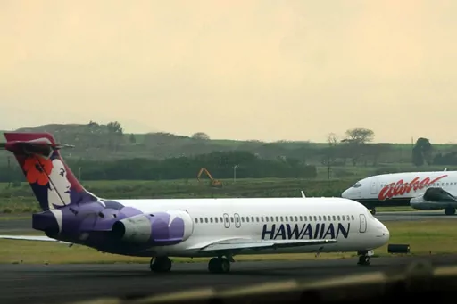 An Hawaiian Airlines plane taxis for position at Kahalui, Hawaii, on the island of Maui, March 24, 2005. Alaska Air Group said Sunday, Dec. 3, 2023, that it agreed to buy Hawaiian Airlines in a $1 billion deal. (AP Photo/Lucy Pemoni, File)