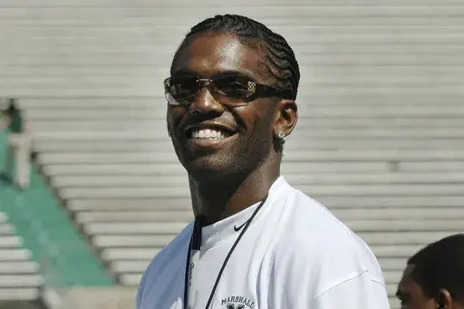 Former Marshall football player Randy Moss of the Oakland Raiders waves to fans prior to serving as an honorary coach during Marshall's annual Green-White game Saturday, April 22, 2006, in Huntington, W.Va. (AP Photo/Jeff Gentner, File)
