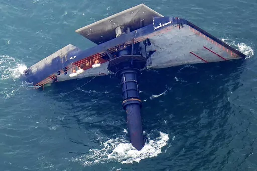 The capsized lift boat Seacor Power is seen seven miles off the coast of Louisiana in the Gulf of Mexico, April 18, 2021. An outage involving a Coast Guard marine warning system and “data gaps” in existing radar systems were contributing factors in last year’s deadly capsizing of an oil industry offshore “lift boat” off of Louisiana’s coast, the National Transportation Safety Board said in a report issued Tuesday, Oct. 18, 2022. (AP Photo/Gerald Herbert, File)