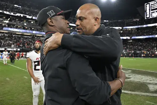 Las Vegas Raiders head coach Antonio Pierce, right, greets Atlanta Falcons head coach Raheem Morris, left, after an NFL football game Dec. 16, 2024, in Las Vegas. (AP Photo/David Becker, File)