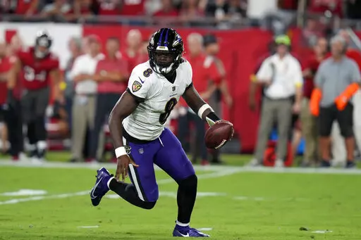 Baltimore Ravens quarterback Lamar Jackson scrambles during the first half of an NFL football game against the Tampa Bay Buccaneers Thursday, Oct. 27, 2022, in Tampa, Fla. (AP Photo/Chris O'Meara)
