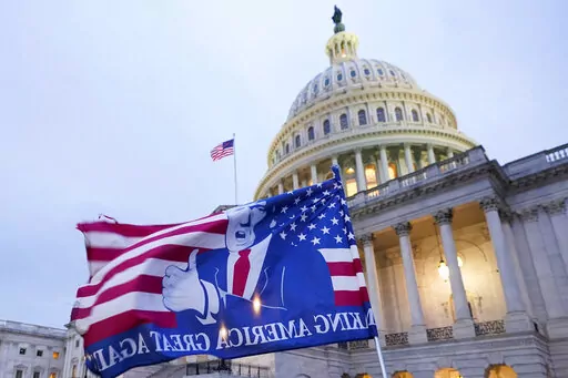 A flag depicting President Donald Trump flies on the East Front of the U.S. Capitol on Jan. 6, 2021, in Washington. (AP Photo/Manuel Balce Ceneta)