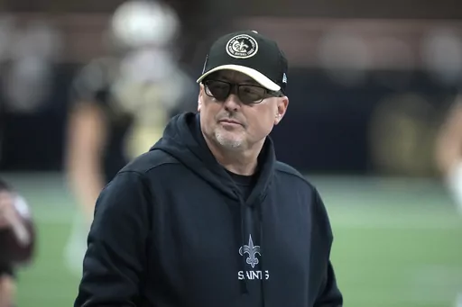 New Orleans Saints offensive coordinator Pete Carmichael Jr. is seen before the start of an NFL football game between the New York Giants and New Orleans Saints Sunday, Dec. 17, 2023, in New Orleans. The New Orleans Saints have fired offensive coordinator Pete Carmichael Jr. along with senior offensive assistant Bob Bicknell and receivers coach Kodi Burns. Saints coach Dennis Allen said in an announcement made Tuesday, Jan. 16, 2024, that the changes were necessary to move forward.(AP Photo/Gera