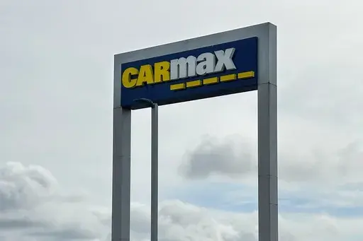 A CarMax sign stands at a location in Colma, Calif., March 4, 2024. (AP Photo/Jeff Chiu, File)
