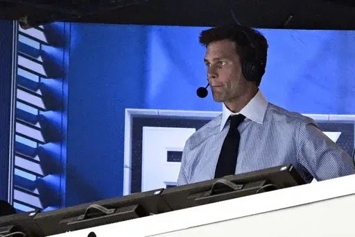 FILE 0- Former NFL quarterback Tom Brady looks on from the broadcast booth during the second half of an NFL football game between the Dallas Cowboys and the New Orleans Saints, Sunday, Sept. 15, 2024, in Arlington, Texas. (AP Photo/Jerome Miron, File)