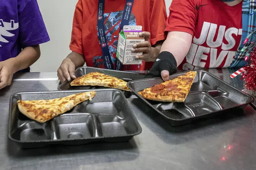 Second-grade students select their meals during their lunch break in the cafeteria, Dec. 12, 2022, at an elementary school in Scottsdale, Ariz. The nation's school meals will get a makeover under new nutrition standards that limit added sugars for the first time, the U.S. Department of Agriculture announced Wednesday, April 24, 2024. (AP Photo/Alberto Mariani, File)