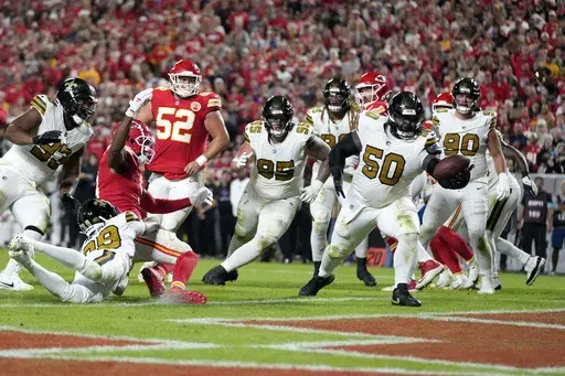 New Orleans Saints defensive tackle Khalen Saunders (50) intercepts a pass in the end zone during the second half of an NFL football game against the Kansas City Chiefs Monday, Oct. 7, 2024, in Kansas City, Mo. (AP Photo/Ed Zurga)
