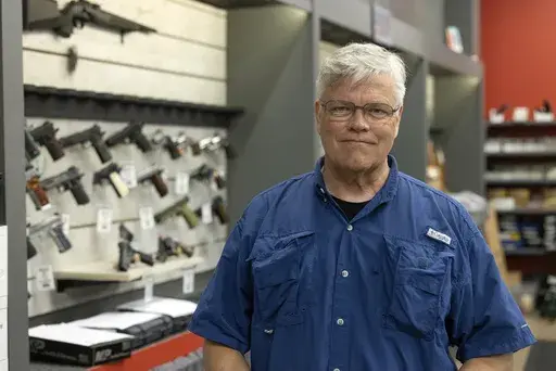 Maxon Shooter's Supplies owner Dan Eldridge poses in his store in Des Plaines, Ill., Tuesday, June 25, 2024. A new national divide is emerging among states over whether to track sales by gun stores. A California law taking effect Monday will require credit card networks to provide banks with special retail codes to assign to gun stores. By contrast, new laws taking effect in Georgia, Iowa, Tennessee and Wyoming will prohibit the use of special gun shop codes in financial transactions. A total of