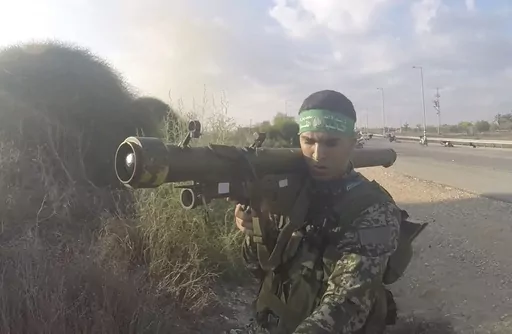 In this image from body camera video during the Oct. 7, 2023, surprise attack on Israel, a Hamas fighter holds a Russian-designed 9M32 Strela anti-aircraft missile. An Associated Press analysis of more than 150 videos and photos taken in the three months of combat since Hamas launched its Oct. 7 surprise attack on Israel shows the militant group has amassed a diverse patchwork arsenal of weapons from around the world – much of it smuggled past a 17-year blockade that was aimed at stopping just