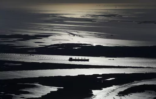 In this aerial photo, a cargo ship plies up the Mississippi River towards New Orleans in Plaquemines Parish, La., Tuesday, March 31, 2015. LSU and Tulane University are receiving a $22 million award from the National Academy of Sciences, Engineering and Medicine to lead a consortium seeking ways to save the ecologically fragile Lower Mississippi River Delta, the universities announced Wednesday, Nov. 1, 2023. (AP Photo/Gerald Herbert, File)