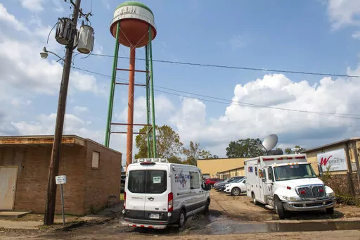 Emergency personnel arrive to evacuate people at a mass shelter, Sept. 2, 2021 in Independence, La. The owner of seven Louisiana nursing homes whose residents suffered in squalid conditions after being evacuated to a warehouse for Hurricane Ida has been arrested. Louisiana Attorney General Jeff Landry says 68-year-old Bob Glynn Dean Jr. faces multiple counts of cruelty to persons with infirmities, Medicaid fraud, and obstruction of justice. Online booking records show that Dean was in custody We