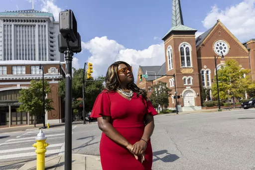 Khadidah Stone stands on the dividing line between her old Alabama congressional District 7, to her right with River City Church, and her new district, District 2, to her left, in downtown Montgomery, Ala., Sept. 20, 2022. The Supreme Court’s decision last June siding with Black voters on a redistricting case in Alabama gave Democrats and voting rights activists a surprise opportunity ahead of the 2024 elections to have congressional maps redrawn in a handful of states. Fast forward three mont