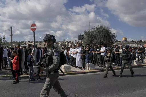 Palestinian Muslim worshipers who were prevented from entering the Al-Aqsa Mosque pray outside Jerusalem's Old City as Israeli forces stand guard on Nov. 17, 2023. ore than 270 Palestinian citizens have been arrested in a crackdown on free speech and political activity since the Hamas attack, according to Adalah, an advocacy organization for Palestinians inside Israel. Palestinian citizens have also reported intimidation, firings and expulsions from universities, as well as surveillance of their