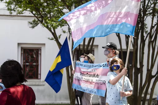 Protestors in support of transgender rights rally outside the Alabama State House in Montgomery, Ala., March 30, 2021. Three days after the U.S. Supreme Court ruled that states can prohibit abortion, Alabama seized on the decision to argue that the state should also be able to ban gender-affirming medical treatments for transgender youth. (Jake Crandall/The Montgomery Advertiser via AP, File)