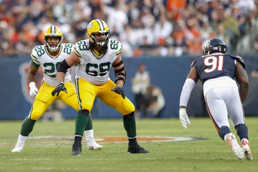 Green Bay Packers offensive tackle David Bakhtiari (69) blocks against Chicago Bears defensive end Yannick Ngakoue (91) during an NFL football game Sept. 10, 2023, in Chicago. Bakhtiari was hoping he had gotten past the knee issues that required him to undergo three separate surgeries and impacted his last two seasons. Now the oldest player on the NFL’s youngest team realizes that’s not the case. (AP Photo/Kamil Krzaczynski, File)