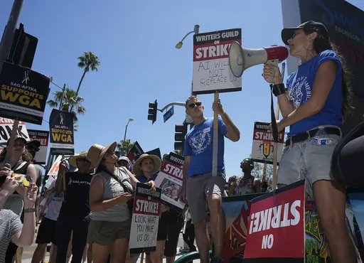Actor and filmmaker Justine Bateman, right, speaks outside Netflix during a Writers Guild rally on July 13, 2023, in Los Angeles. Bateman said she was disturbed that AI models were "ingesting 100 years of film" and TV in a way that could destroy the structure of the film business and replace large portions of its labor pipeline. (AP Photo/Mark J. Terrill, File)