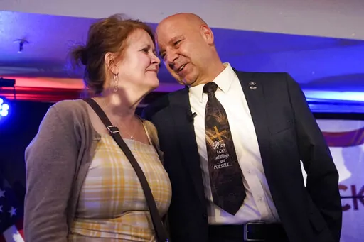 State Sen. Doug Mastriano, R-Franklin, a Republican candidate for Governor of Pennsylvania, talks with his wife Rebbeca at a primary night election gathering in Chambersburg, Pa., Tuesday, May 17, 2022. (AP Photo/Carolyn Kaster)