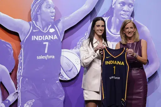 Iowa's Caitlin Clark, left, poses for a photo with WNBA commissioner Cathy Engelbert, right, after being selected first overall by the Indiana Fever during the first round of the WNBA basketball draft, April 15, 2024, in New York. (AP Photo/Adam Hunger, File)